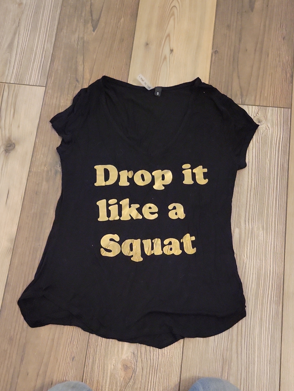 just be Black V-Neck Short Sleeve Tee with Gold 'Drop it like a Squat' Graphic